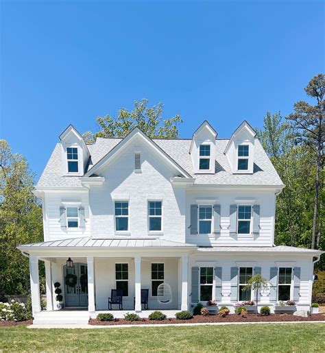 white house with blue metal roof|blue houses with white shutters.